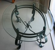 Oval glass topped powder coated green wrought iron table